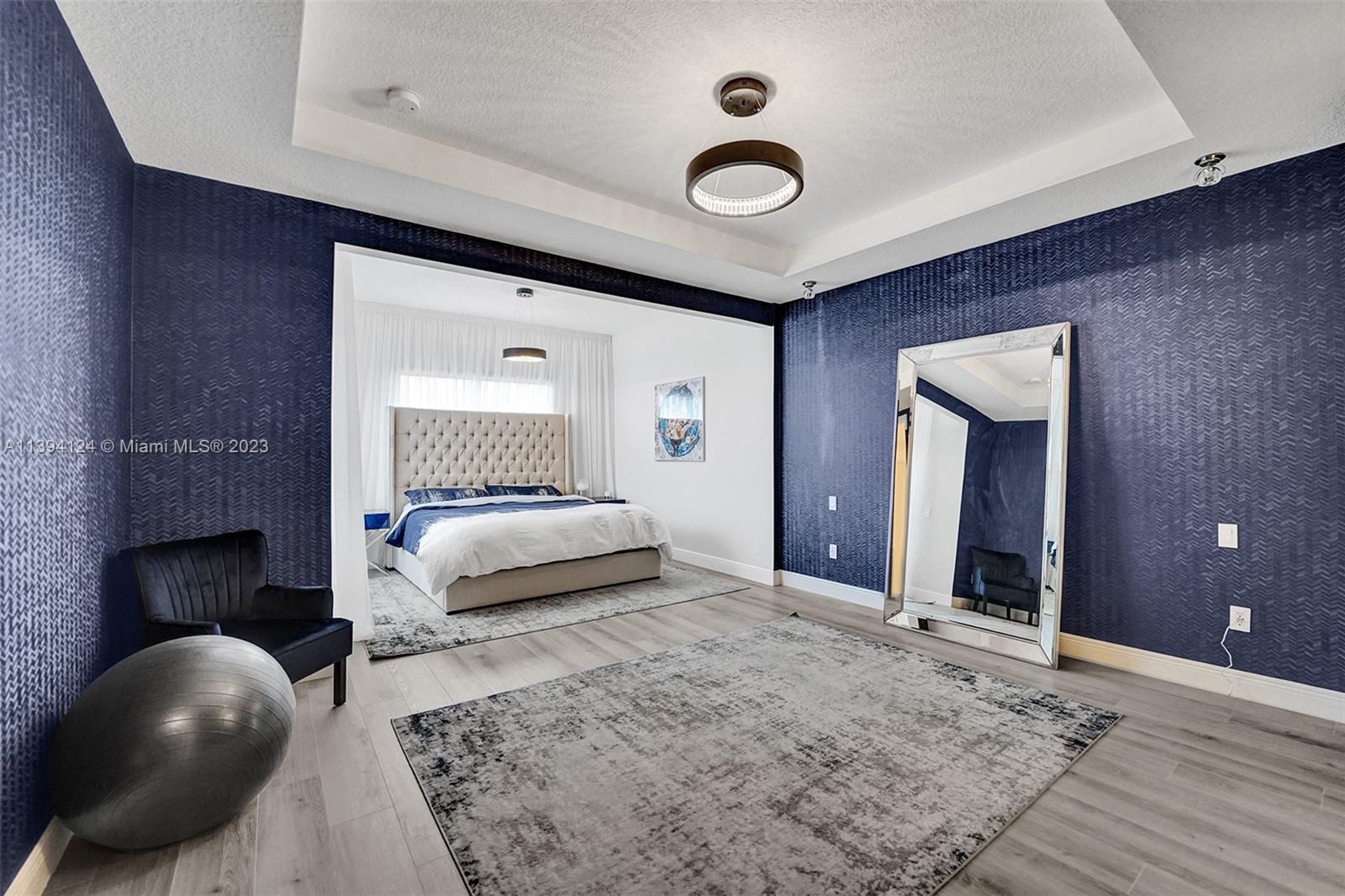 1033 Eucalyptus Drive Hollywood, FL 33021 - Photo 17 of 66 a bedroom with a bed and a large mirror