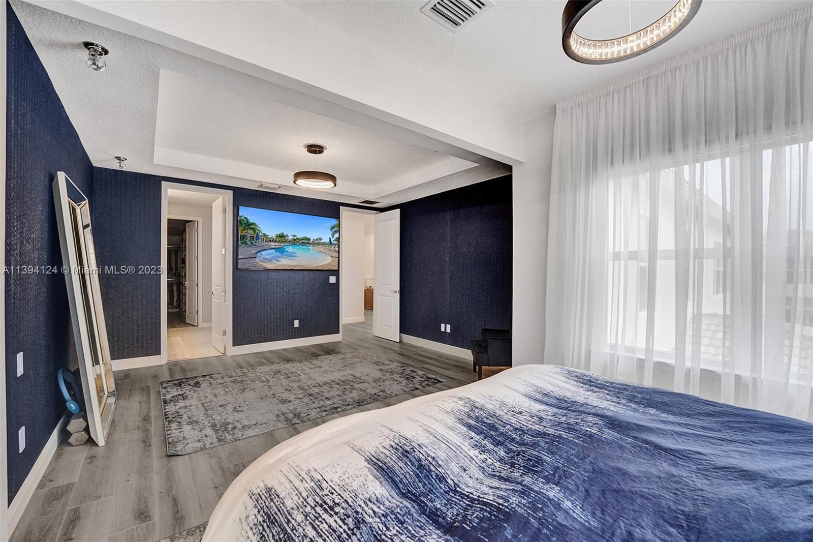 1033 Eucalyptus Drive Hollywood, FL 33021 - Photo 19 of 66 a bedroom with a bed and a large mirror on the dresser