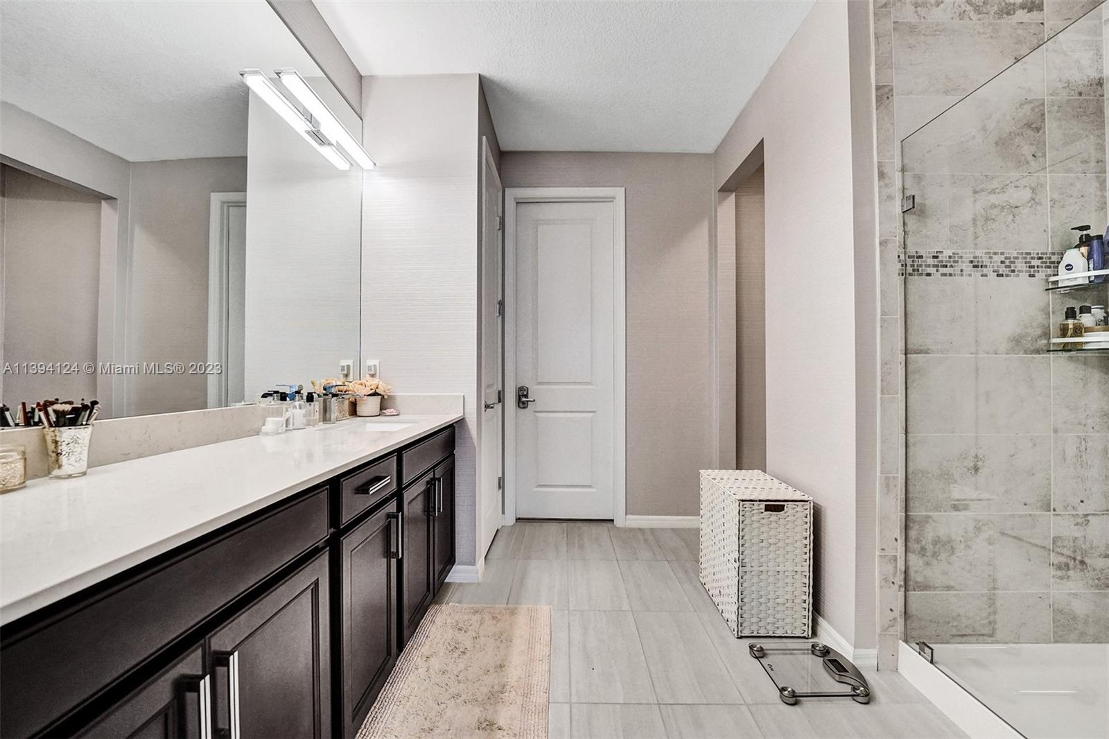 1033 Eucalyptus Drive Hollywood, FL 33021 - Photo 21 of 66 a bathroom with a double vanity sink a mirror and a shower