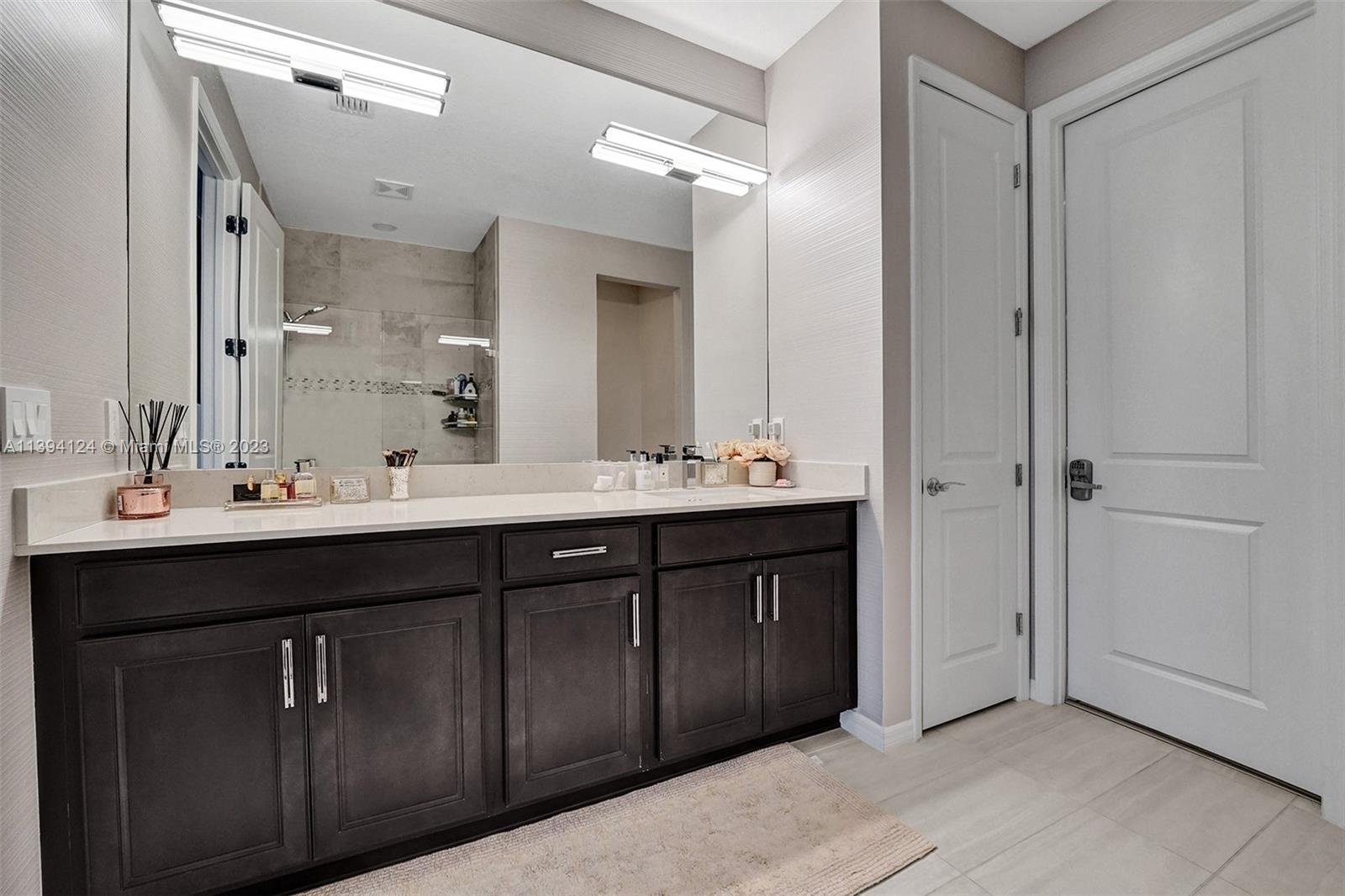 1033 Eucalyptus Drive Hollywood, FL 33021 - Photo 22 of 66 a bathroom with a double vanity sink and mirror