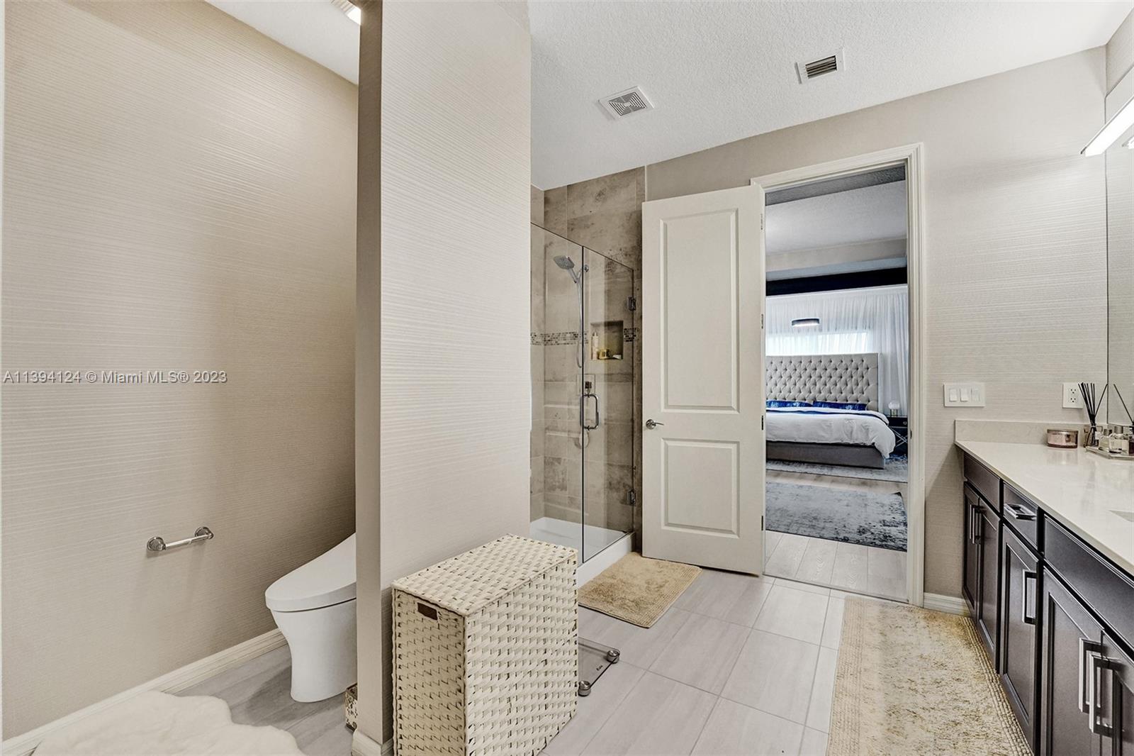 1033 Eucalyptus Drive Hollywood, FL 33021 - Photo 23 of 66 a bathroom with a granite countertop sink a toilet and shower