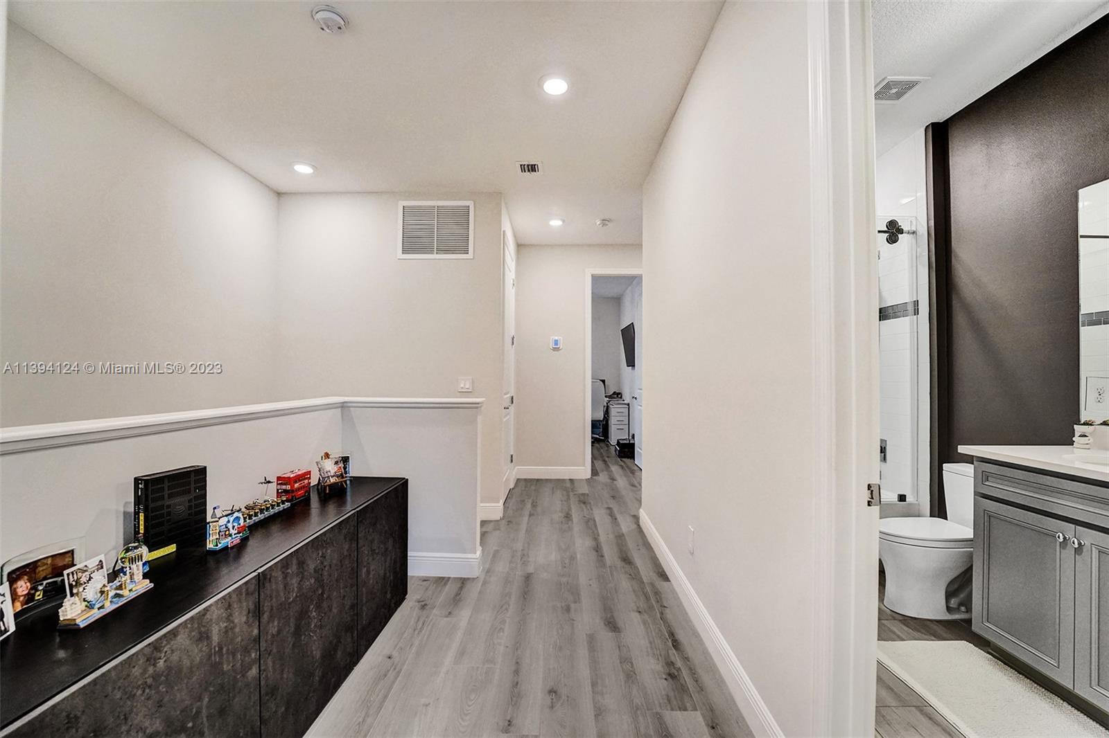 1033 Eucalyptus Drive Hollywood, FL 33021 - Photo 26 of 66 a view of a hallway with wooden floor and a bathroom