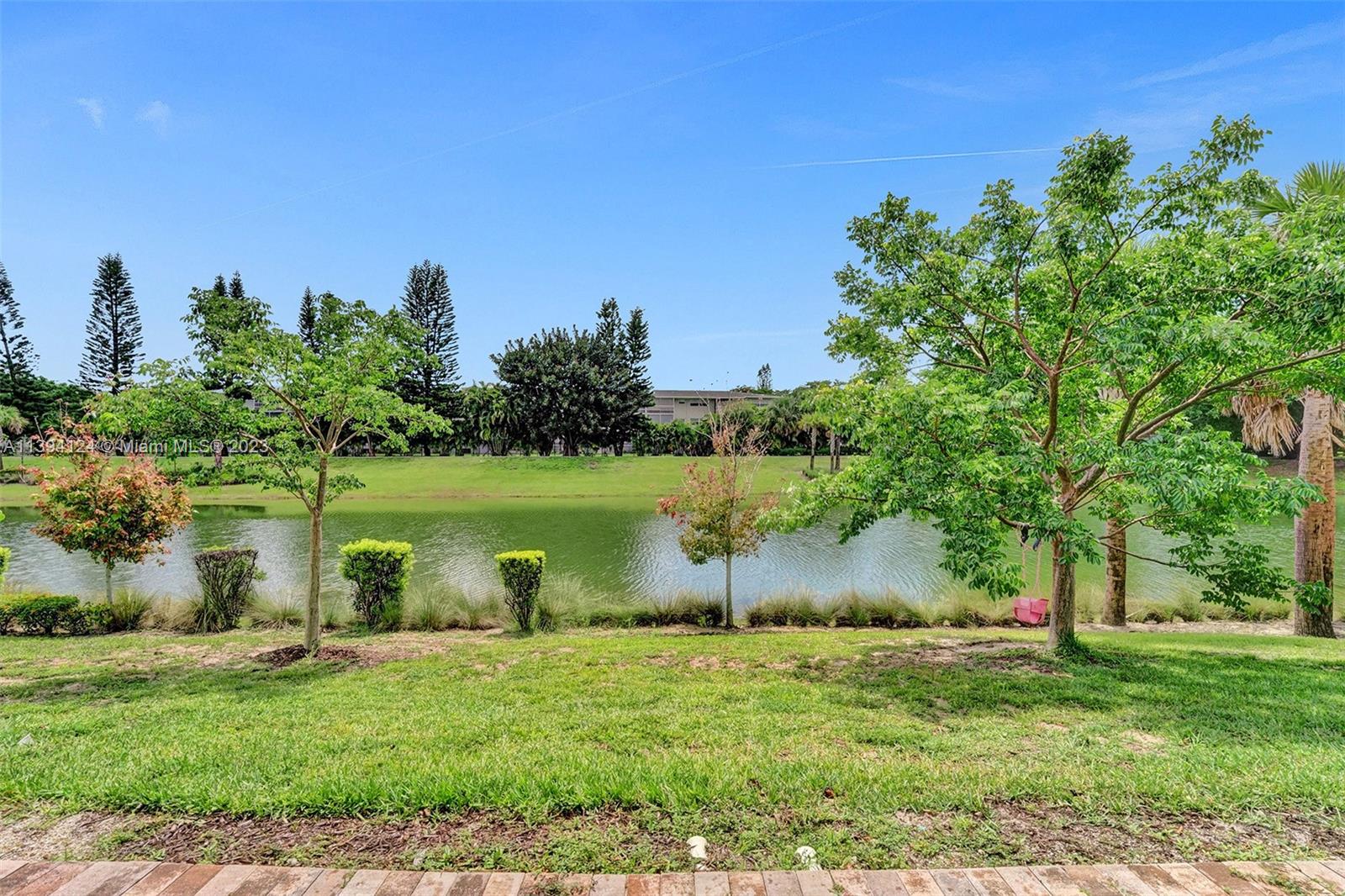 1033 Eucalyptus Drive Hollywood, FL 33021 - Photo 40 of 66 a view of a lake with a yard