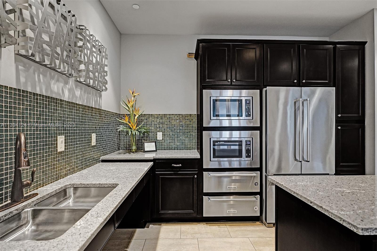 1033 Eucalyptus Drive Hollywood, FL 33021 - Photo 48 of 66 a kitchen with granite countertop stainless steel appliances and cabinets