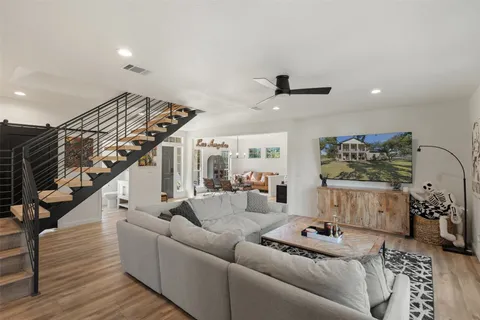 a living room with furniture and wooden floor