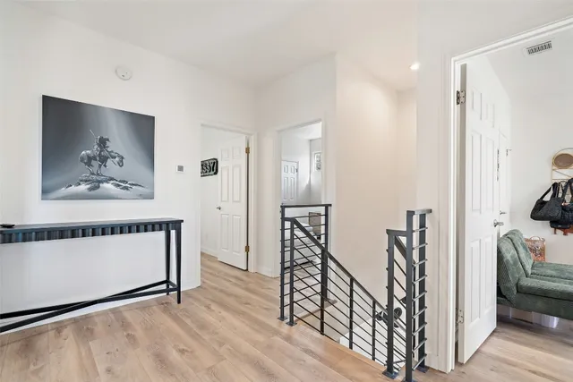 a view of hallway with furniture and wooden floor