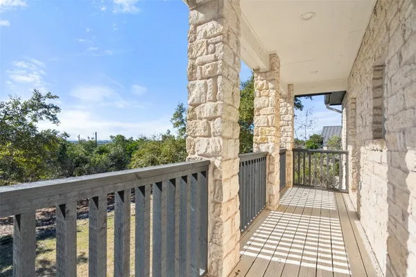 a view of a balcony with wooden floor