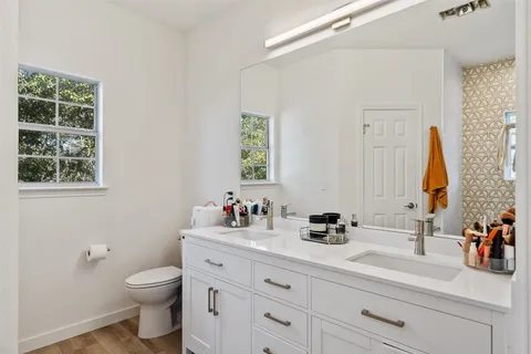 a bathroom with a toilet sink and mirror