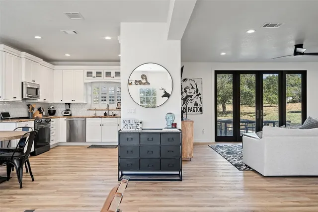 a large kitchen with kitchen island a large counter space a sink stainless steel appliances and cabinets