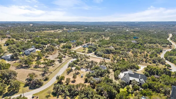 an aerial view of residential houses with city view