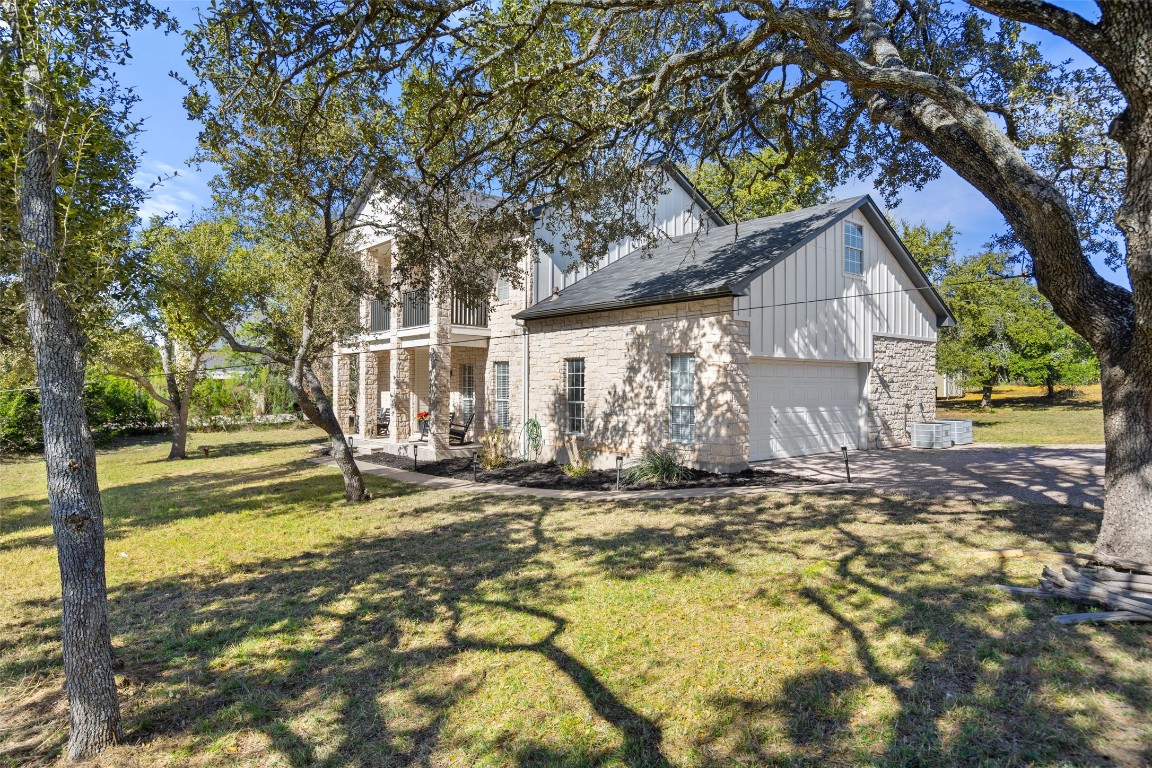 310 Saddle Blanket Drive Dripping Springs, TX 78620 - Photo 4 of 40 a view of a house with backyard and a tree