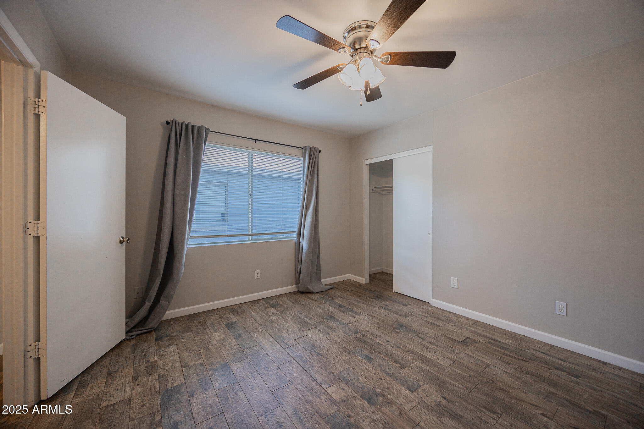 1507 East Harvard Street, Unit A Phoenix, AZ 85006 - Photo 11 of 14 an empty room with closet and windows