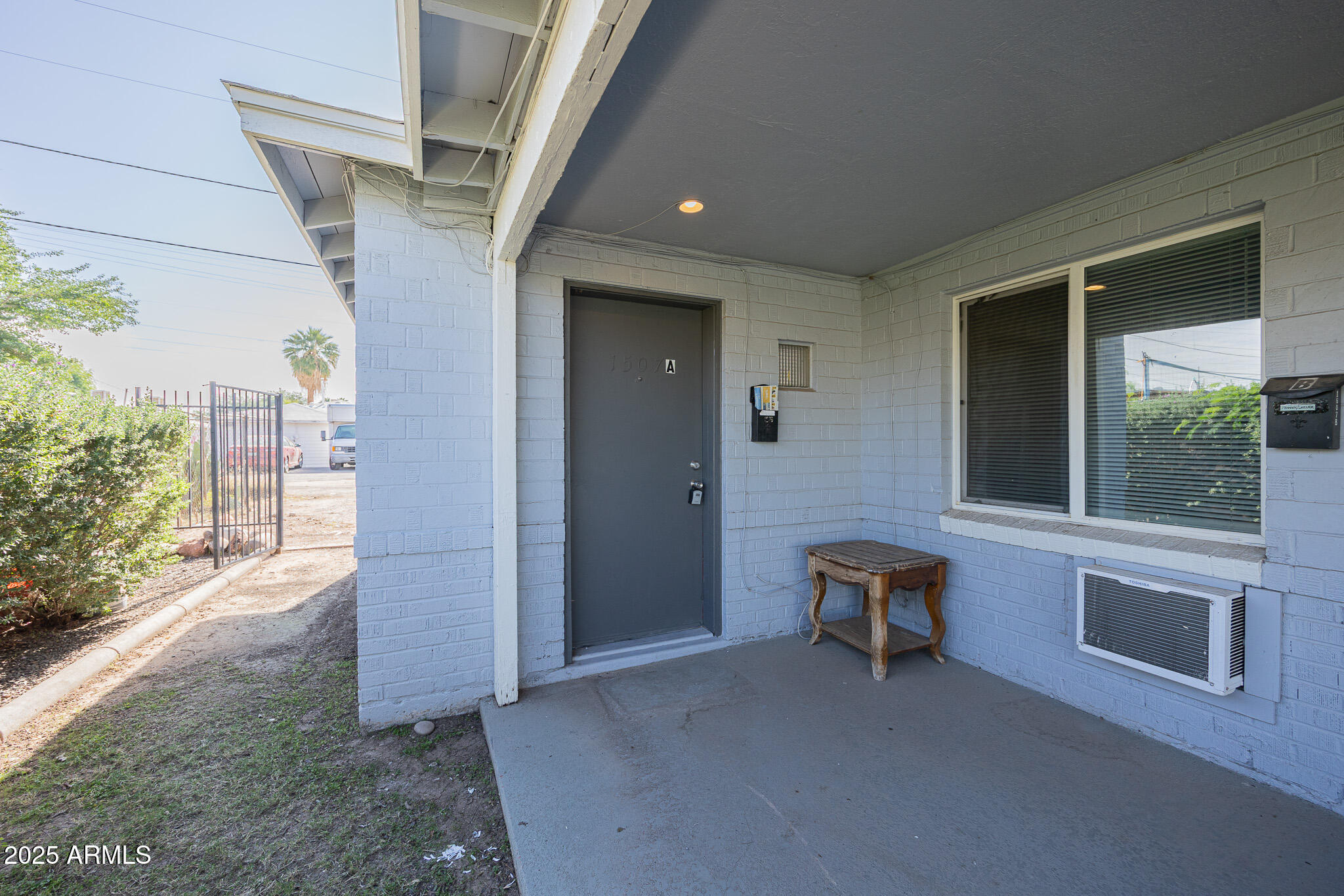 1507 East Harvard Street, Unit A Phoenix, AZ 85006 - Photo 2 of 14 a view of an entryway with a door and chair