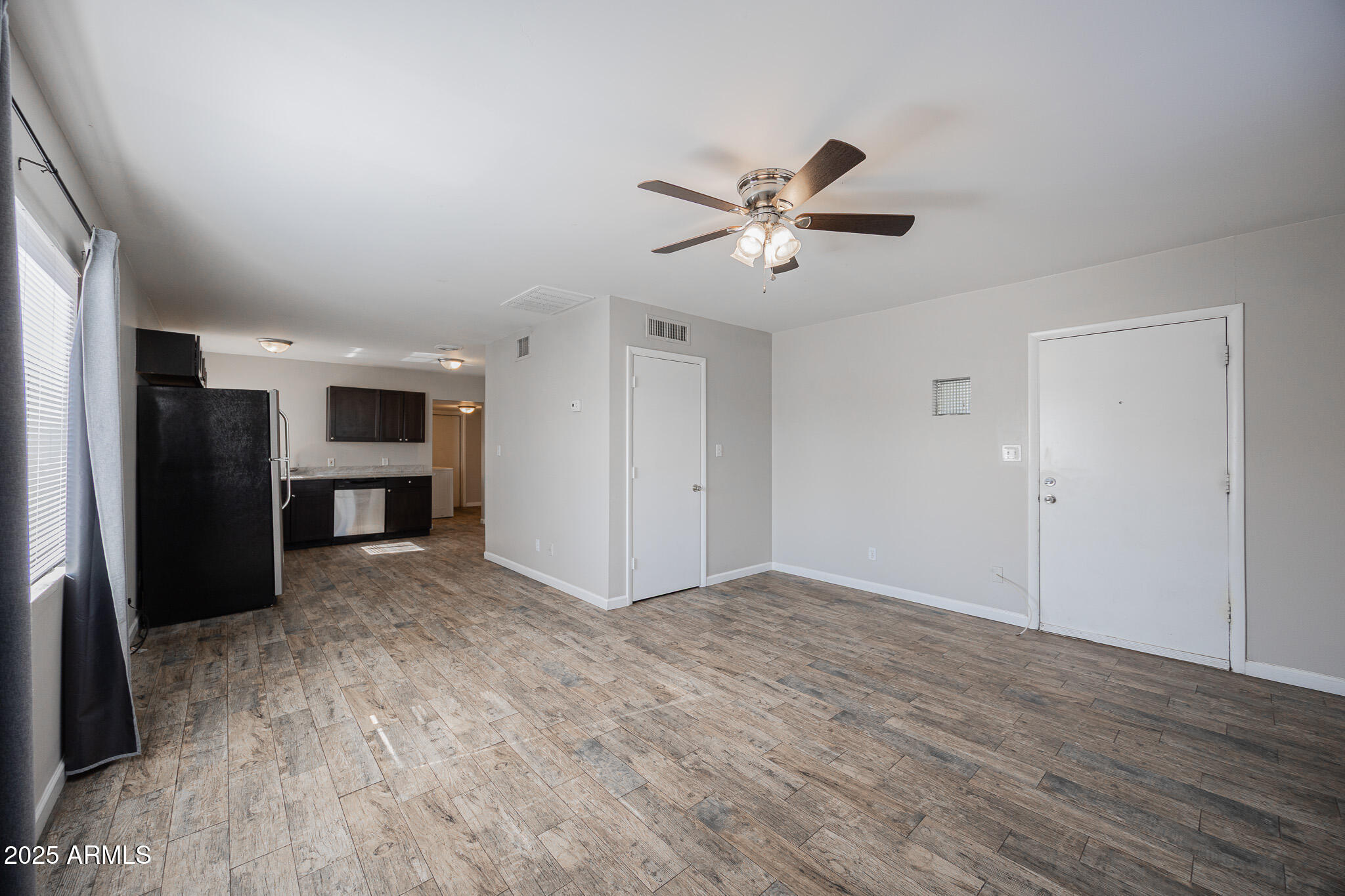 1507 East Harvard Street, Unit A Phoenix, AZ 85006 - Photo 4 of 14 a view of empty room with wooden floor and ceiling fan