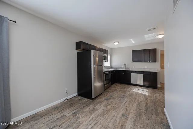 a kitchen with stainless steel appliances a refrigerator and a sink