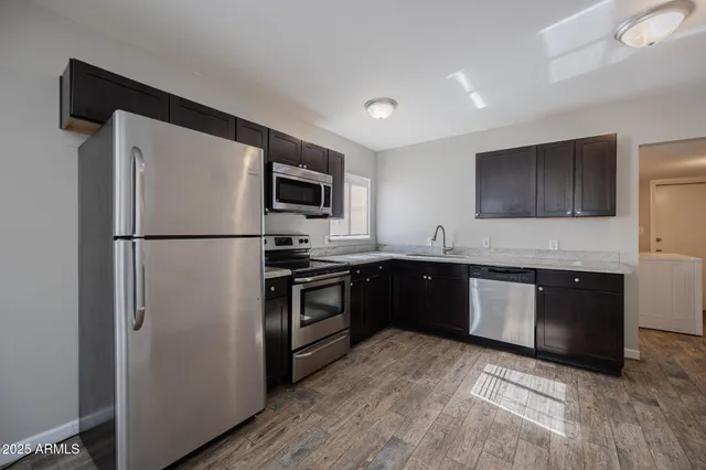 a kitchen with a refrigerator stove and sink