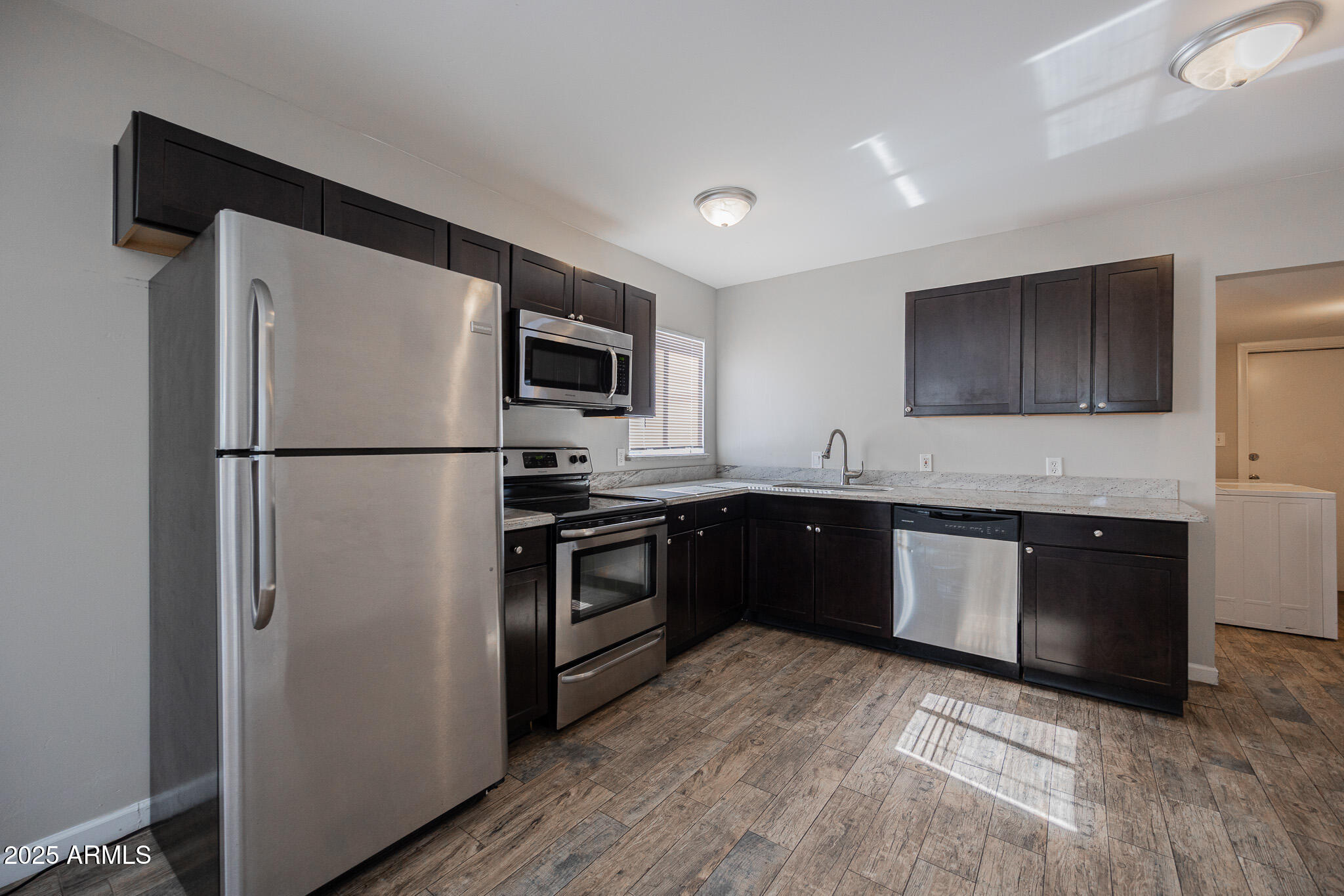 1507 East Harvard Street, Unit A Phoenix, AZ 85006 - Photo 7 of 14 a kitchen with a refrigerator stove and sink