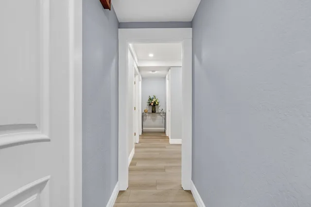 a view of a hallway view with wooden floor and staircase