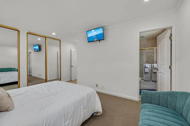 a bedroom with a bed and a couch