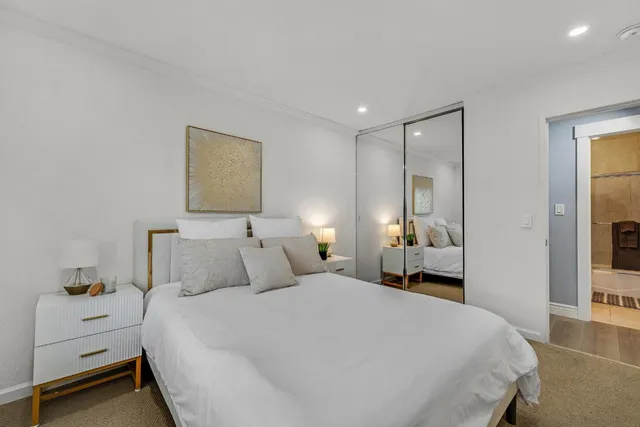 a bedroom with a bed and a night stand