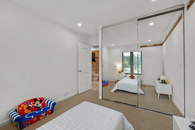 a bedroom with furniture and a large window