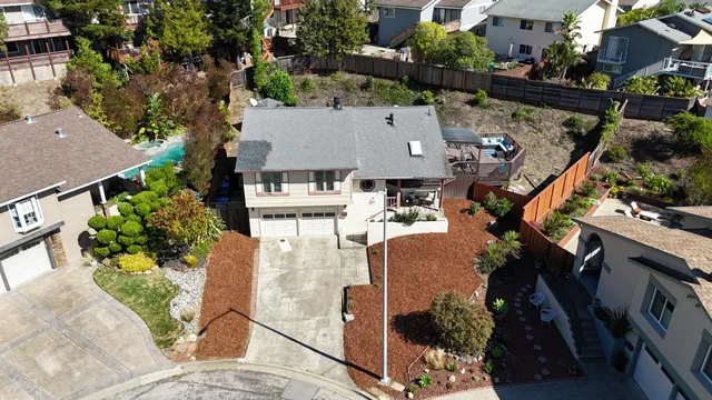 an aerial view of a house with a yard patio and lake view