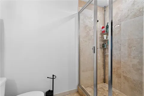 a view of a hallway with bathroom and front door