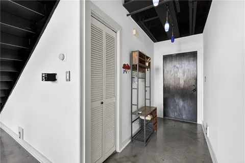 a view of hallway with wooden floor and stairs