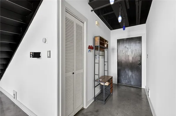 a view of hallway with wooden floor and stairs