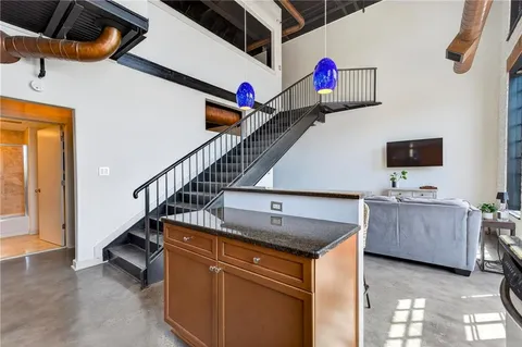 a kitchen with stainless steel appliances granite countertop a sink stove and cabinets