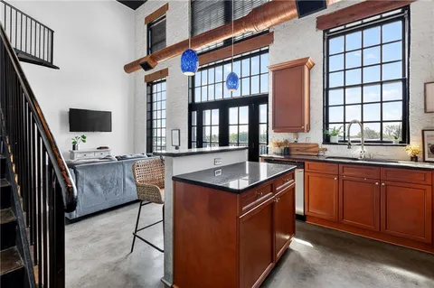 a kitchen with stainless steel appliances granite countertop a sink and a window