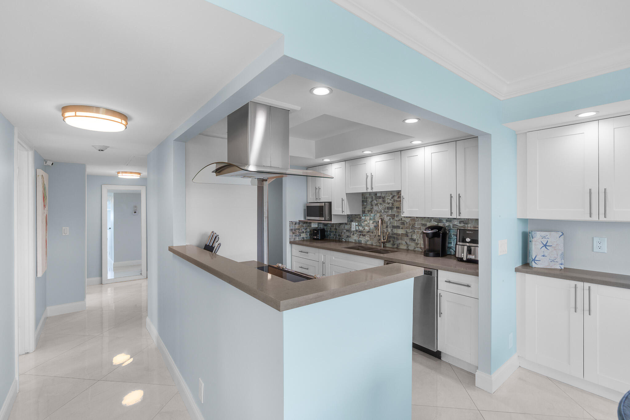 950 Ponce De Leon Road, Unit 401 Boca Raton, FL 33432 - Photo 11 of 35 a kitchen with stainless steel appliances kitchen island a refrigerator sink and cabinets