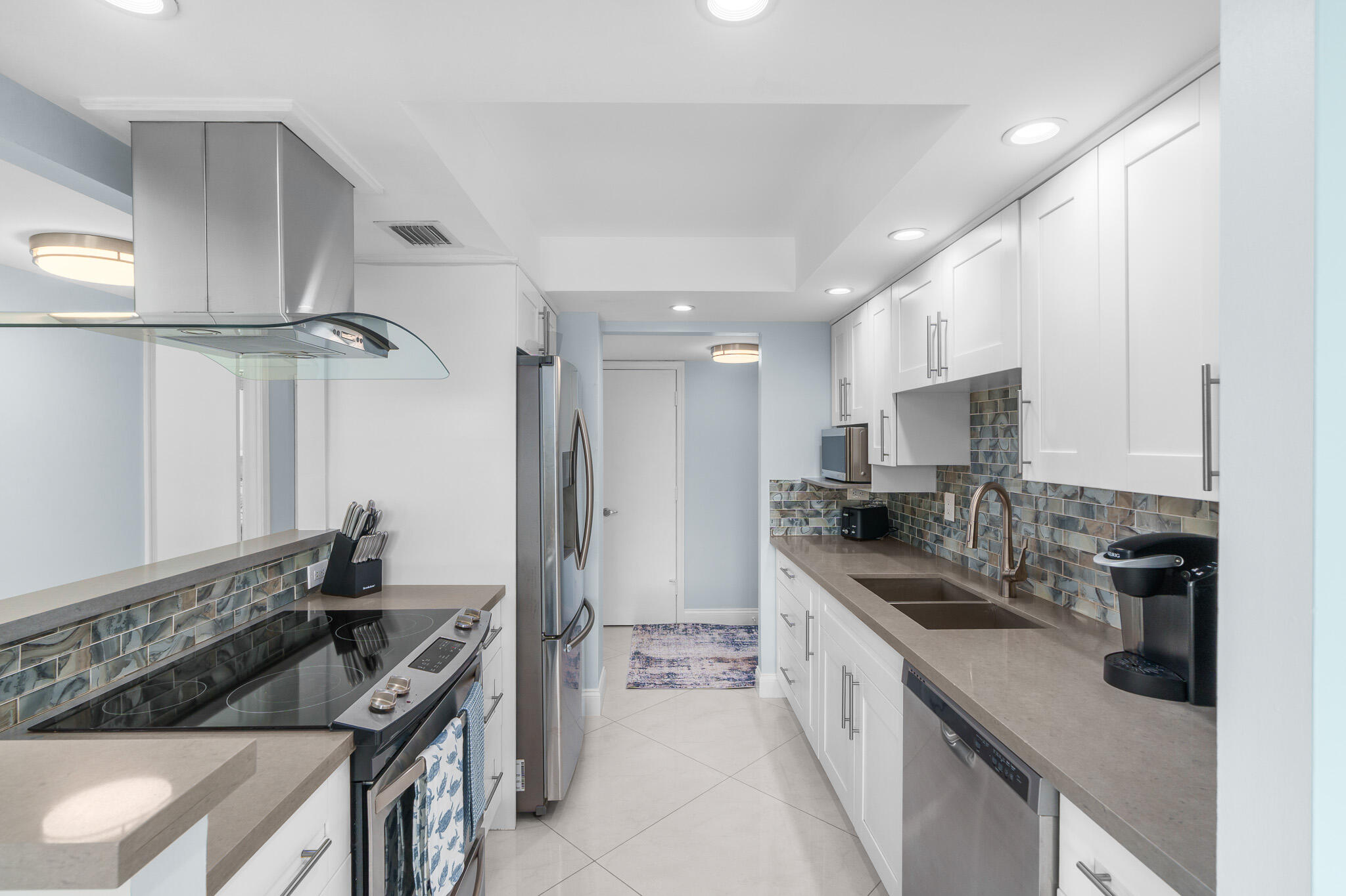950 Ponce De Leon Road, Unit 401 Boca Raton, FL 33432 - Photo 12 of 35 a kitchen with stainless steel appliances granite countertop a sink stove and refrigerator