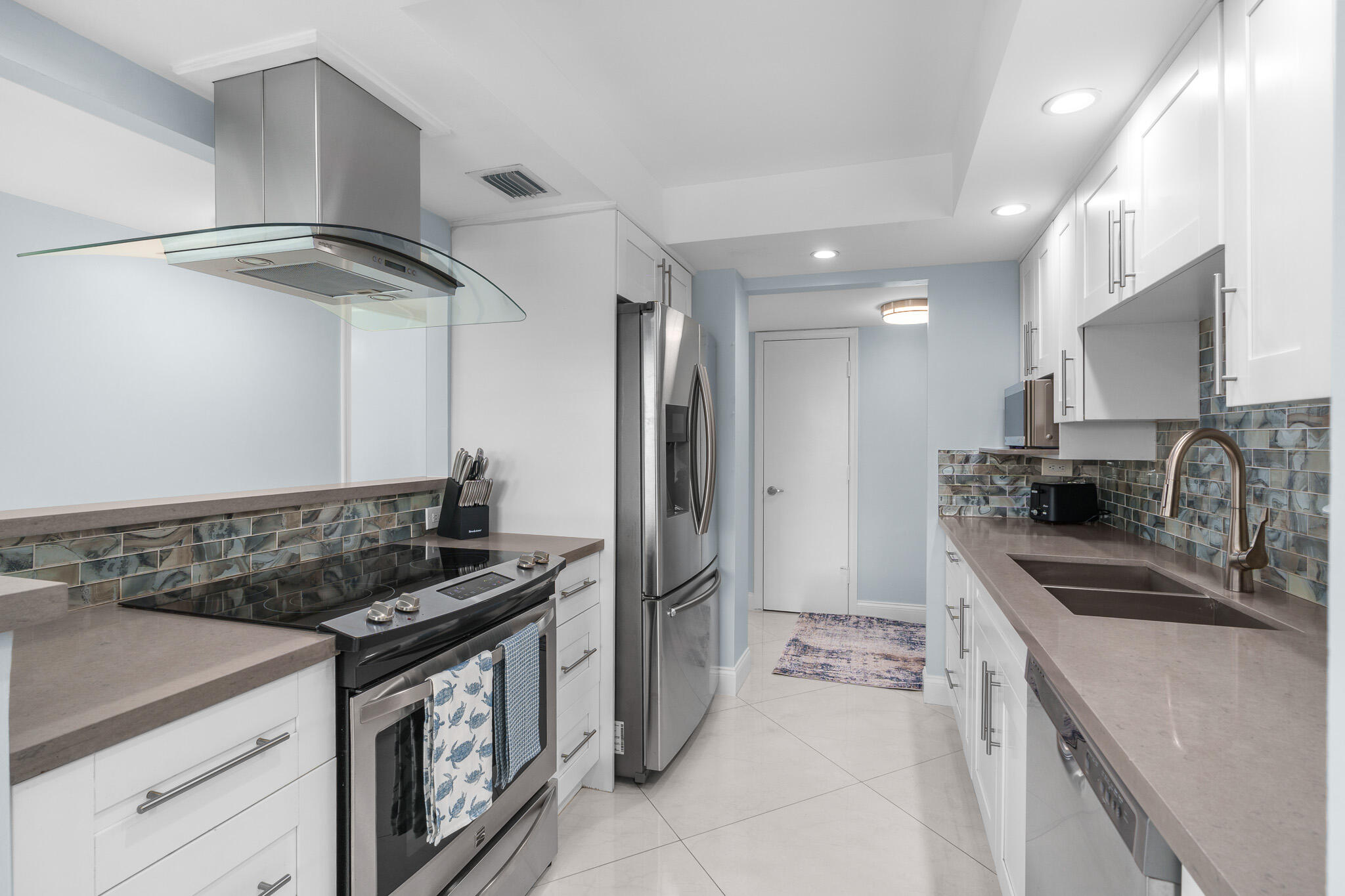 950 Ponce De Leon Road, Unit 401 Boca Raton, FL 33432 - Photo 13 of 35 a kitchen that has a sink and a stove