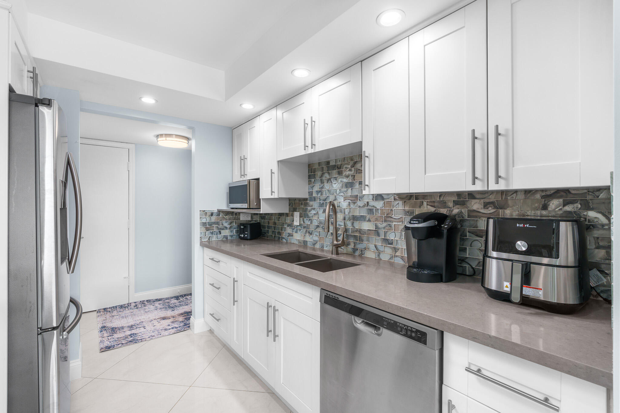950 Ponce De Leon Road, Unit 401 Boca Raton, FL 33432 - Photo 14 of 35 a kitchen with stainless steel appliances granite countertop a refrigerator and a sink