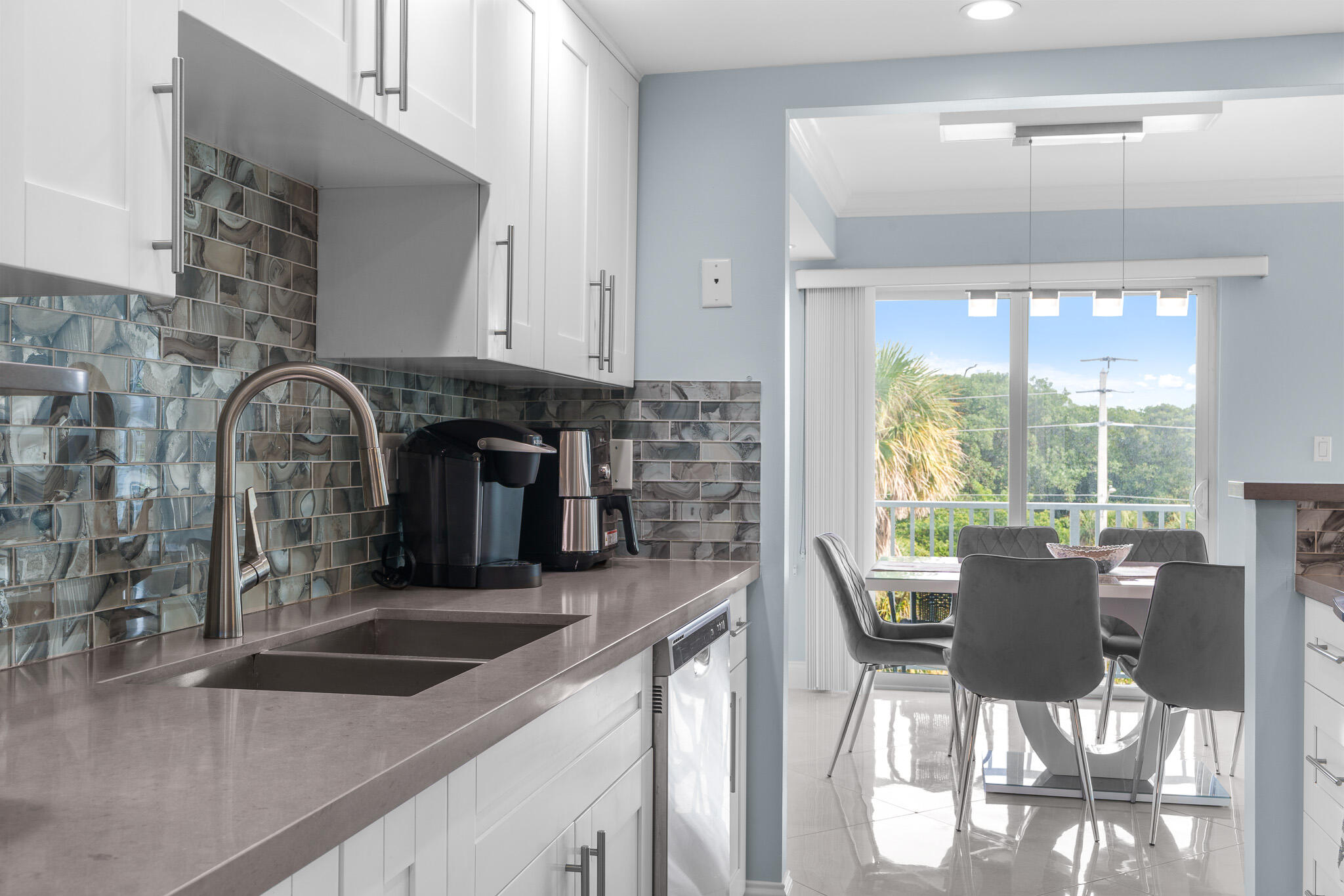 950 Ponce De Leon Road, Unit 401 Boca Raton, FL 33432 - Photo 16 of 35 a kitchen with a sink and large windows