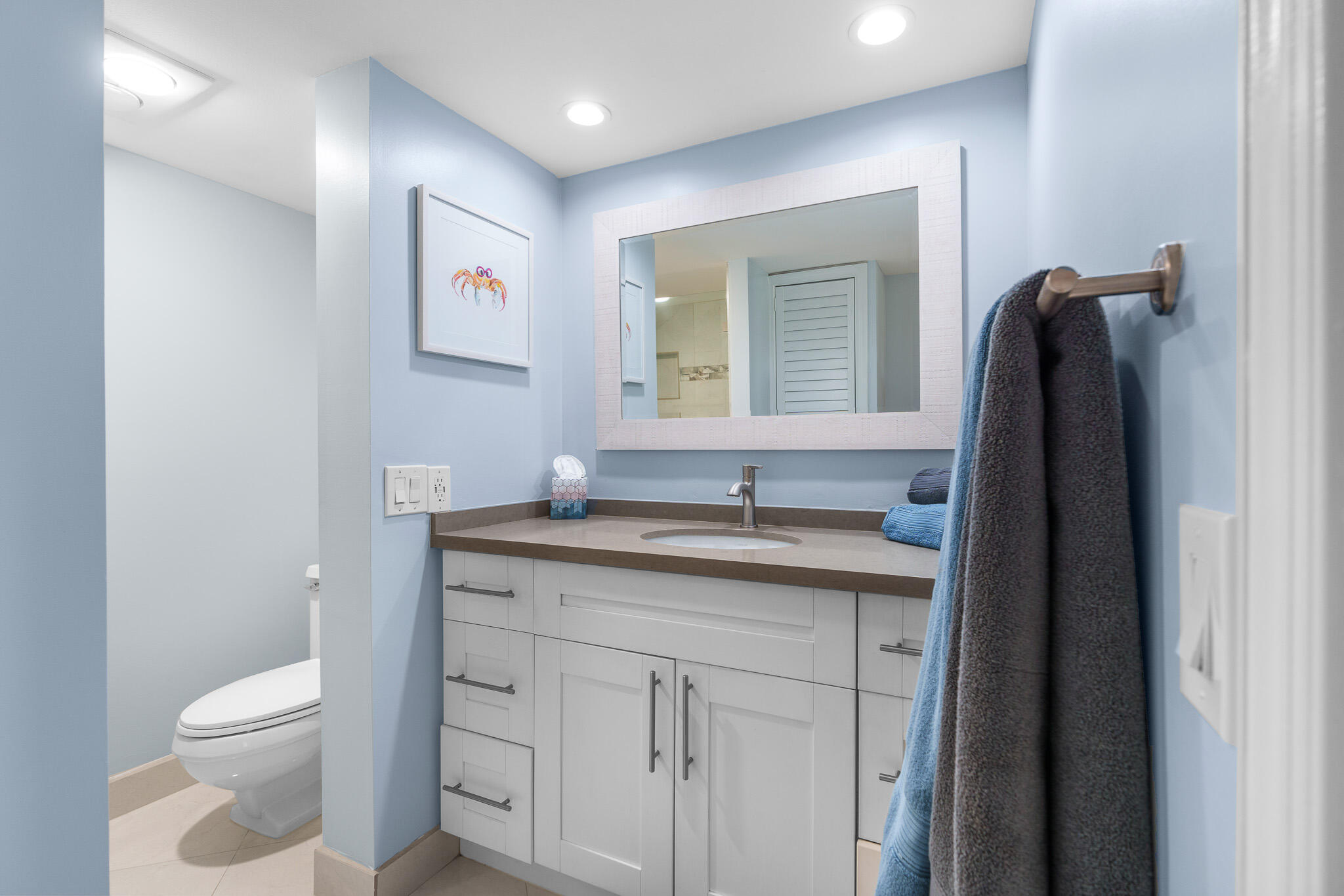 950 Ponce De Leon Road, Unit 401 Boca Raton, FL 33432 - Photo 21 of 35 a bathroom with a toilet sink and mirror