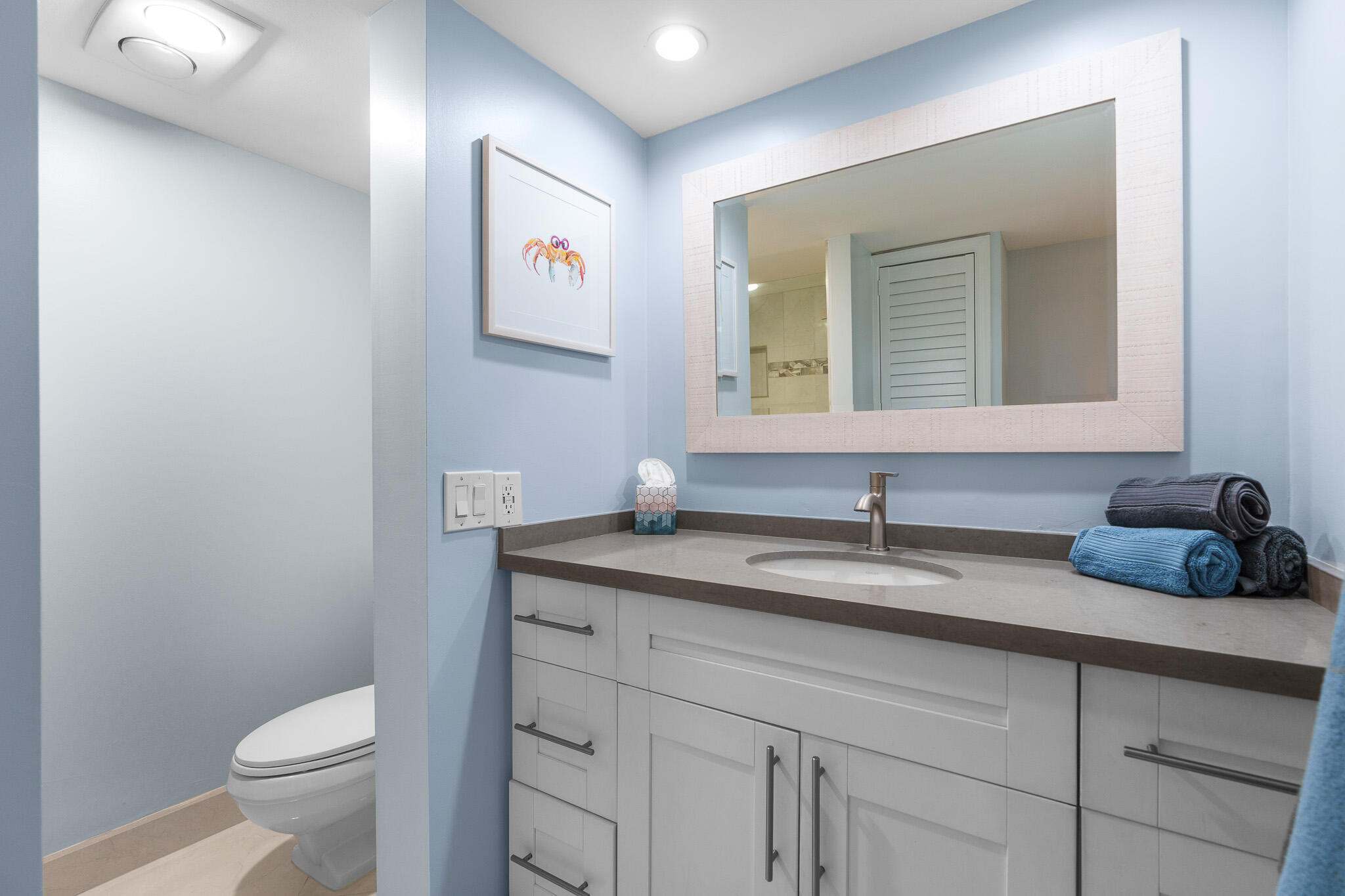 950 Ponce De Leon Road, Unit 401 Boca Raton, FL 33432 - Photo 22 of 35 a bathroom with a toilet sink and mirror