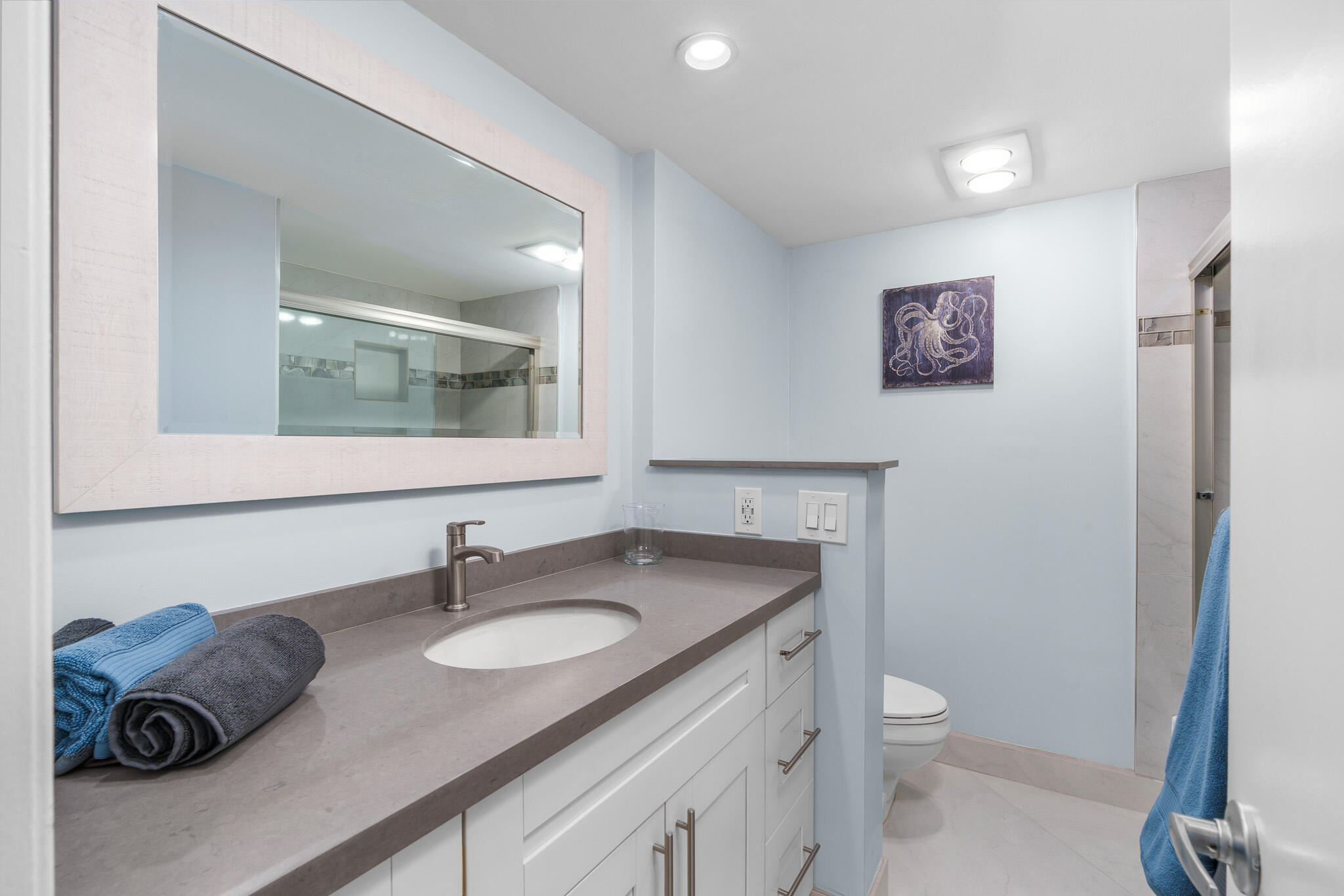 950 Ponce De Leon Road, Unit 401 Boca Raton, FL 33432 - Photo 28 of 35 a bathroom with a granite countertop toilet sink and mirror