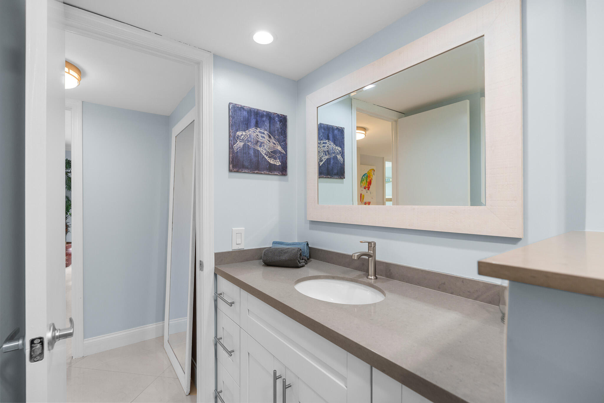 950 Ponce De Leon Road, Unit 401 Boca Raton, FL 33432 - Photo 30 of 35 a bathroom with a granite countertop sink and a mirror