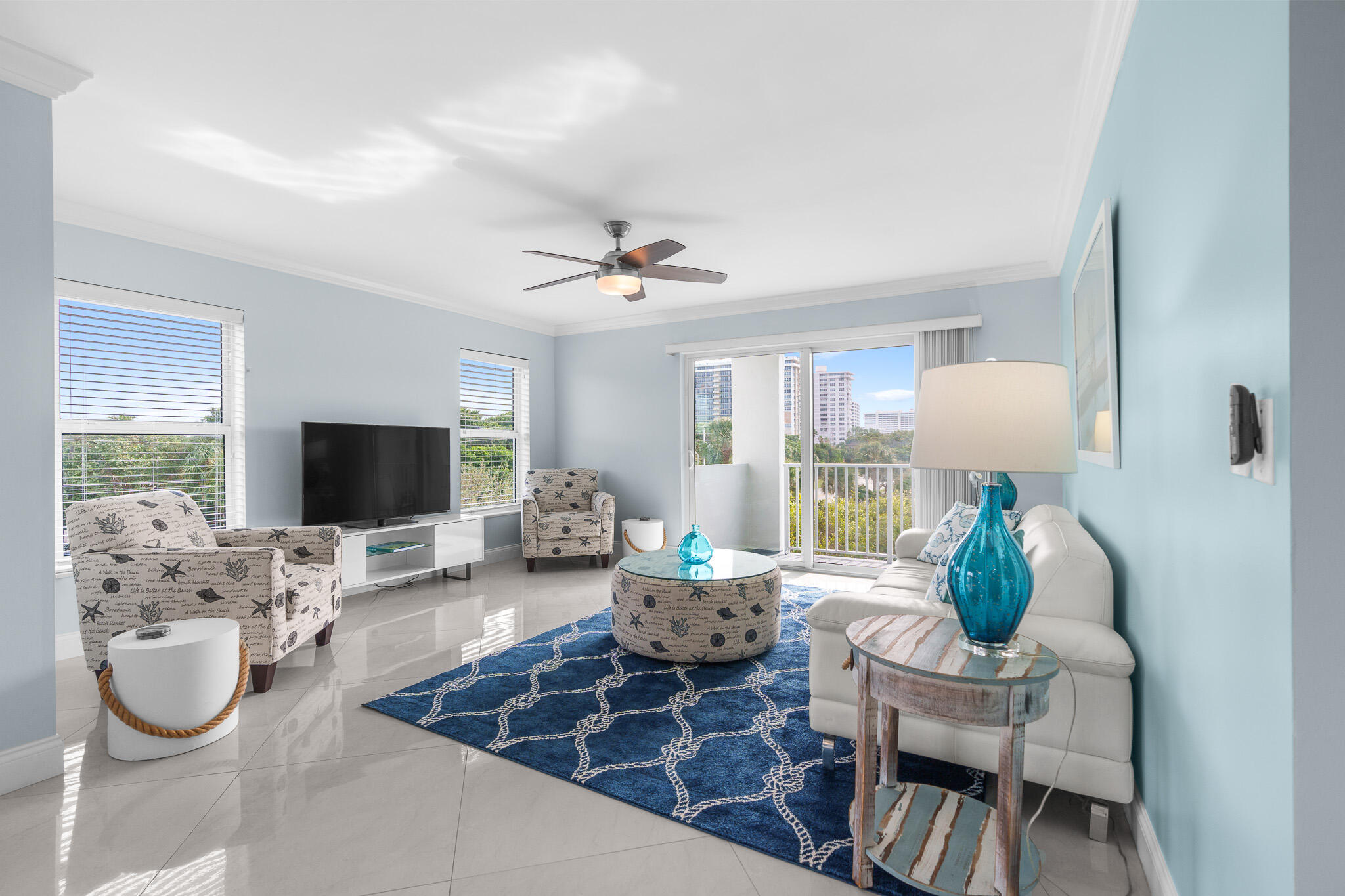 950 Ponce De Leon Road, Unit 401 Boca Raton, FL 33432 - Photo 4 of 35 a living room with furniture and a flat screen tv