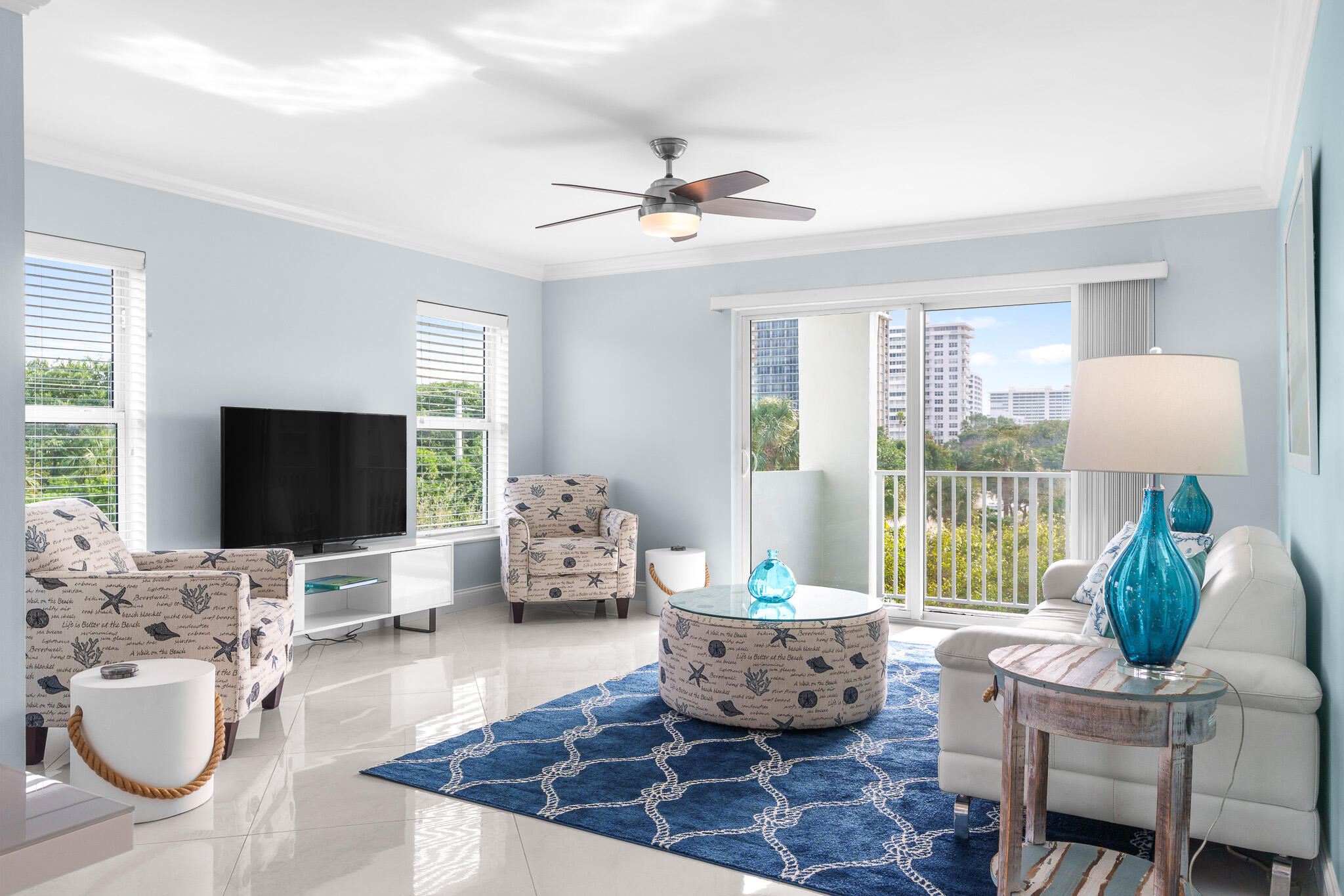 950 Ponce De Leon Road, Unit 401 Boca Raton, FL 33432 - Photo 5 of 35 a living room with furniture and a flat screen tv
