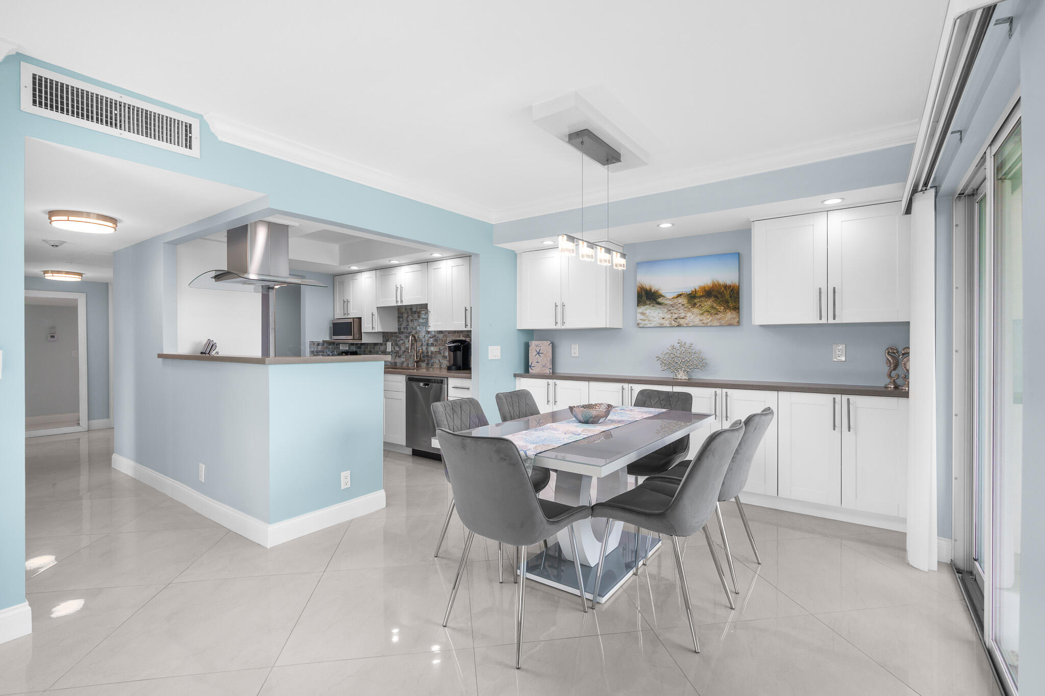 950 Ponce De Leon Road, Unit 401 Boca Raton, FL 33432 - Photo 8 of 35 a kitchen with a table and chairs in it