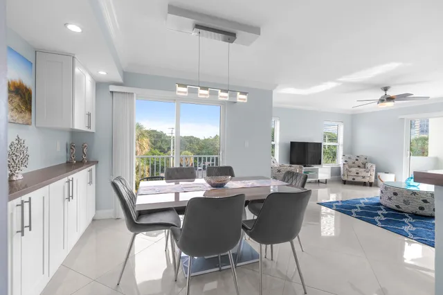 a dining room with furniture a large window and a fireplace