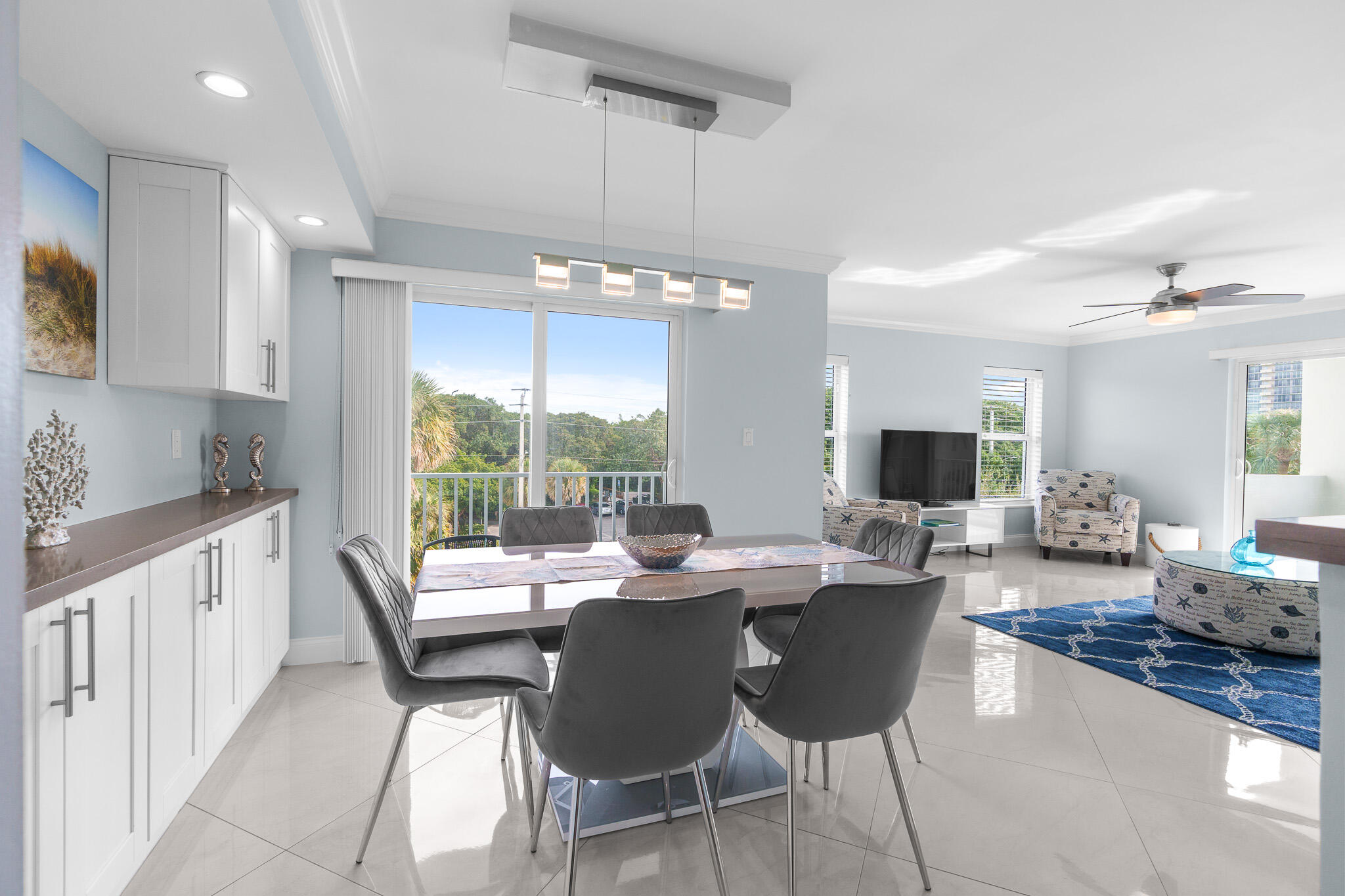 950 Ponce De Leon Road, Unit 401 Boca Raton, FL 33432 - Photo 10 of 35 a dining room with furniture a large window and a fireplace