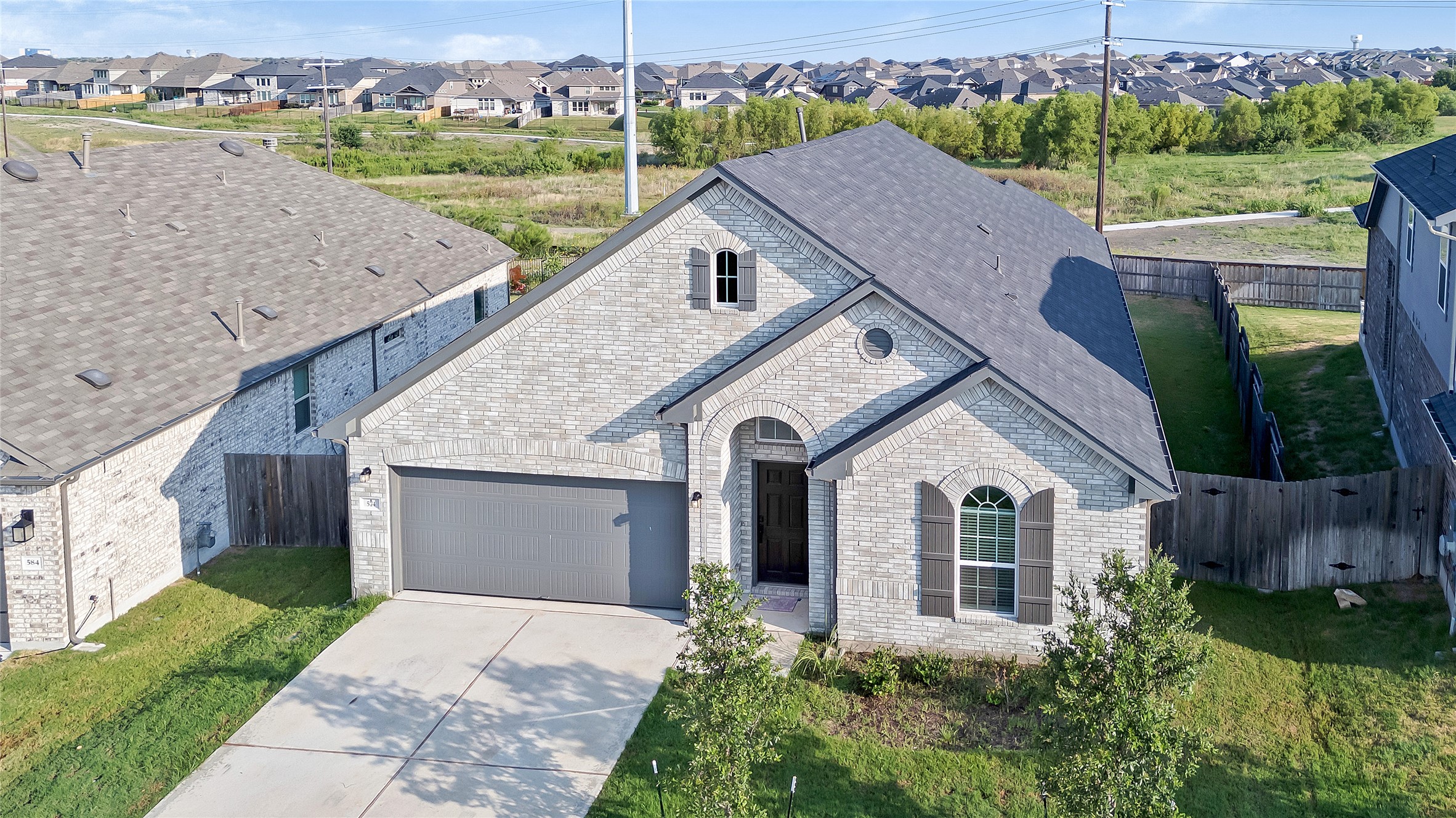 574 Sugar Cane Buda, TX 78610 - Photo 29 of 35 a aerial view of a house with a yard and table and chairs