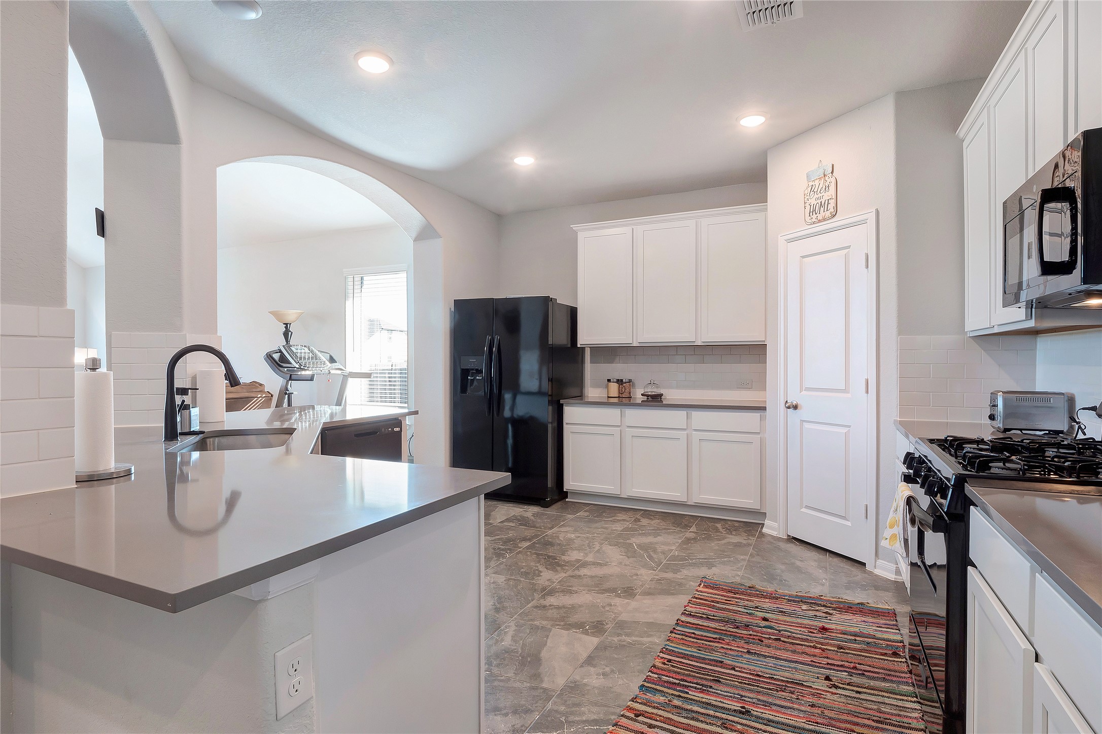 574 Sugar Cane Buda, TX 78610 - Photo 7 of 35 a kitchen with refrigerator and cabinets