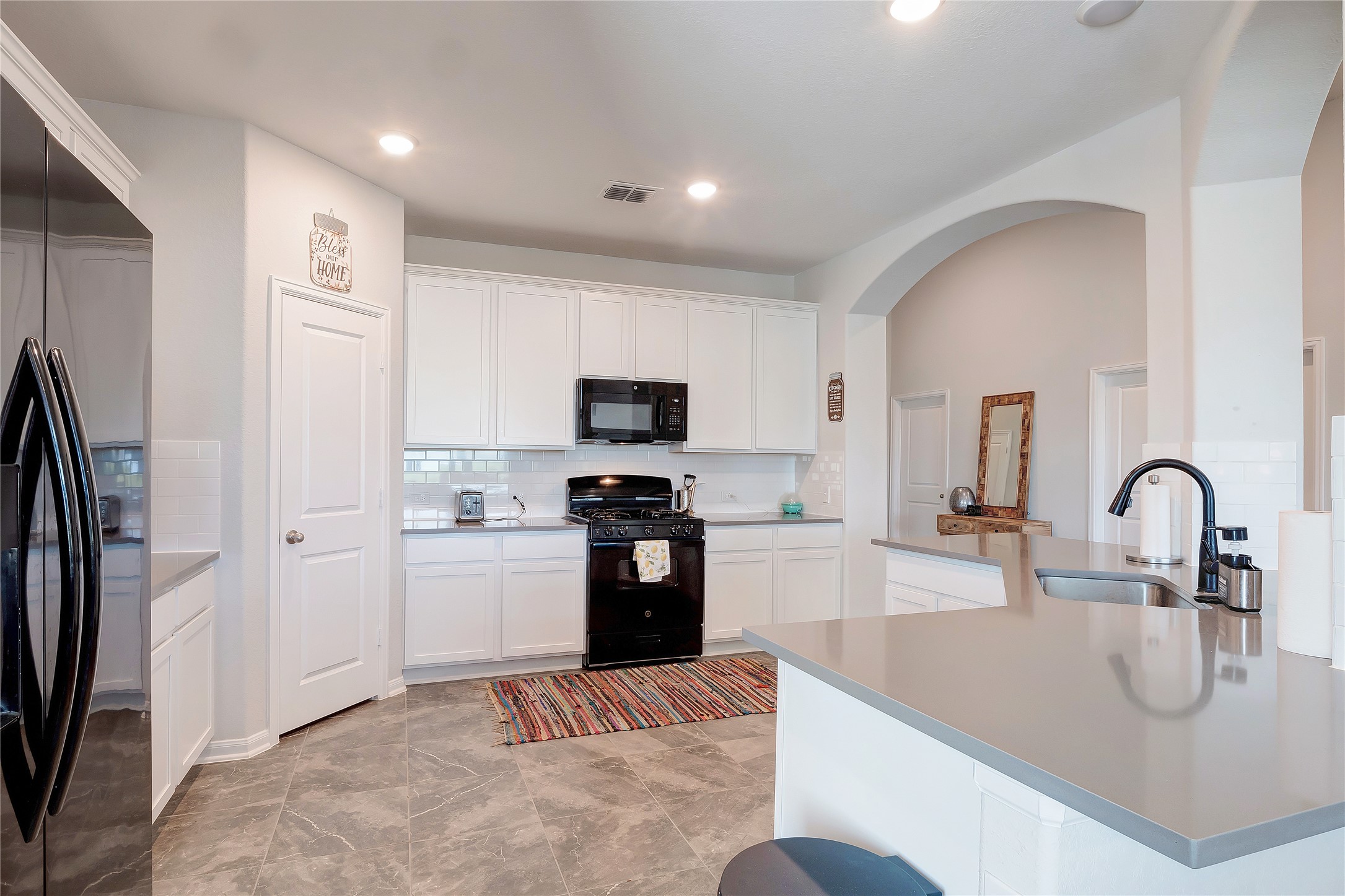 574 Sugar Cane Buda, TX 78610 - Photo 8 of 35 a kitchen with stainless steel appliances granite countertop a refrigerator and a sink