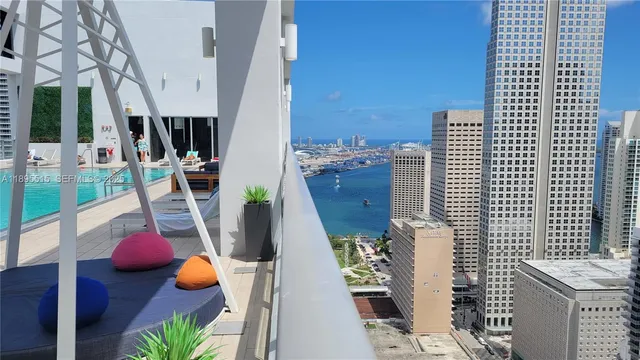 a view of a balcony with couches and wooden floor