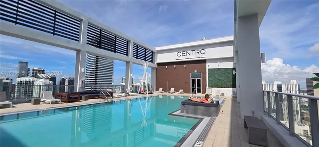 a view of swimming pool with outdoor seating